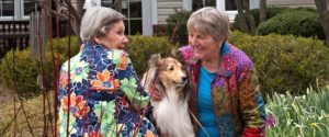 residents sitting with dog in garden