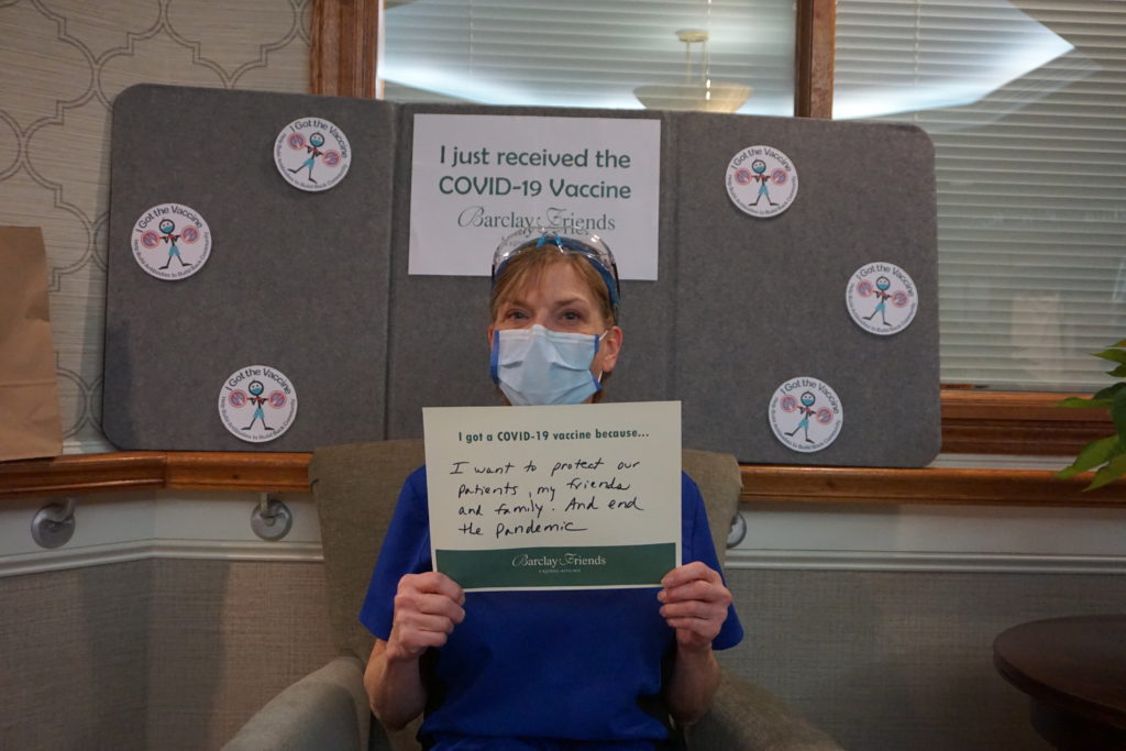 Barclay Friends Employee with vaccine sign