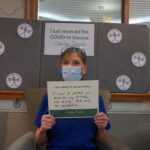 Barclay Friends Employee with vaccine sign