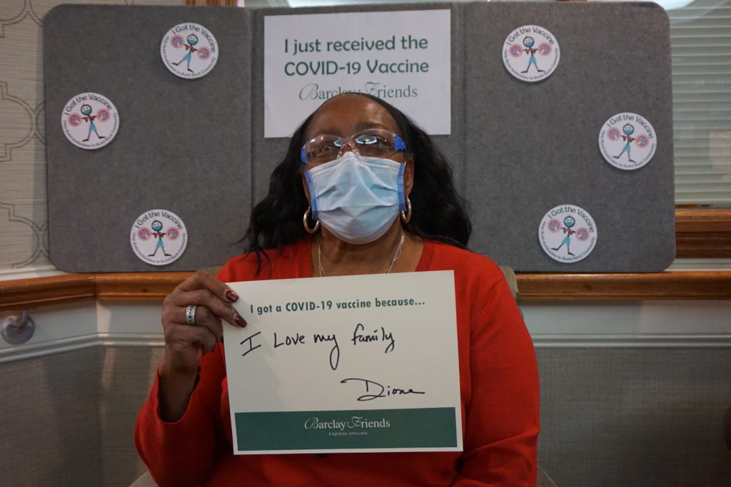 Barclay Friends Employee with vaccine sign