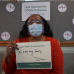 Barclay Friends Employee with vaccine sign