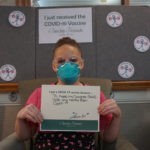 Barclay Friends Employee with vaccine sign