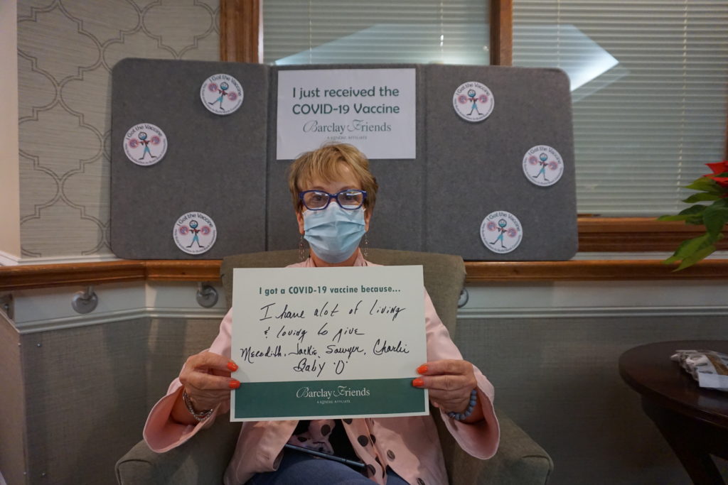 Barclay Friends Employee with vaccine sign