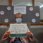 Barclay Friends Employee with vaccine sign