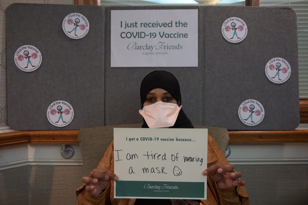 Barclay Friends Employee with vaccine sign