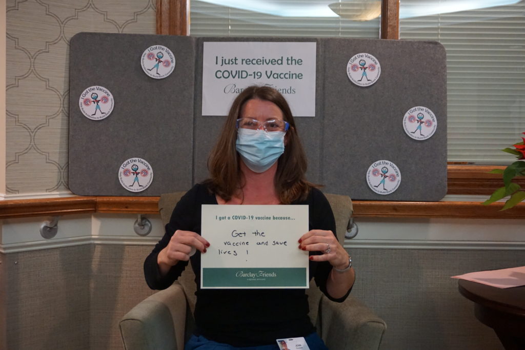 Barclay Friends Employee with vaccine sign