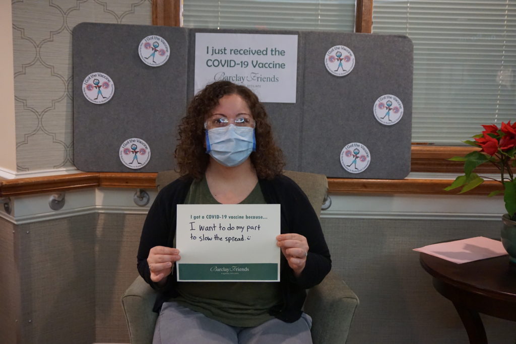Barclay Friends Employee with vaccine sign