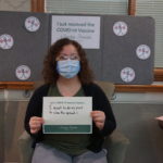 Barclay Friends Employee with vaccine sign
