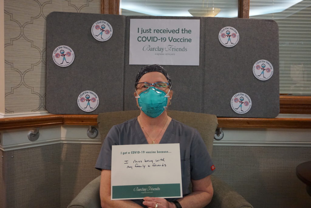Barclay Friends Employee with vaccine sign