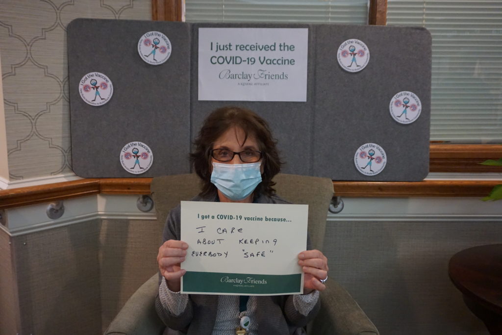 Barclay Friends Employee with vaccine sign
