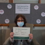 Barclay Friends Employee with vaccine sign