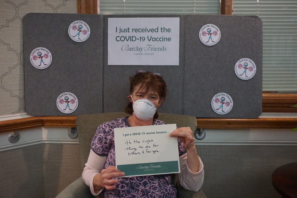 Barclay Friends Employee with vaccine sign