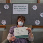 Barclay Friends Employee with vaccine sign