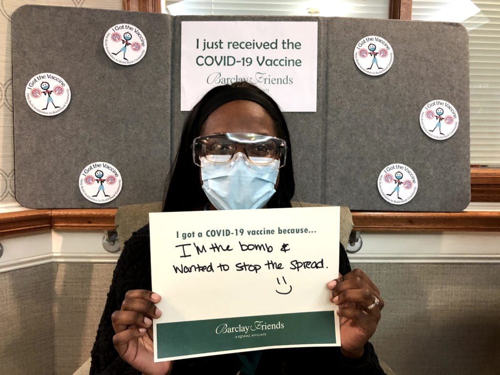 Barclay Friends Employee with vaccine sign