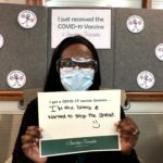 Barclay Friends Employee with vaccine sign