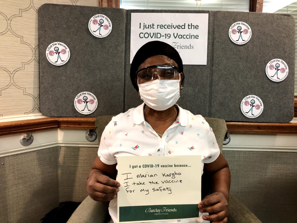 Barclay Friends Employee with vaccine sign