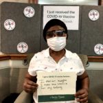 Barclay Friends Employee with vaccine sign