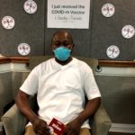Barclay Friends Employee with vaccine sign