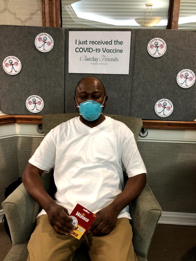Barclay Friends Employee with vaccine sign
