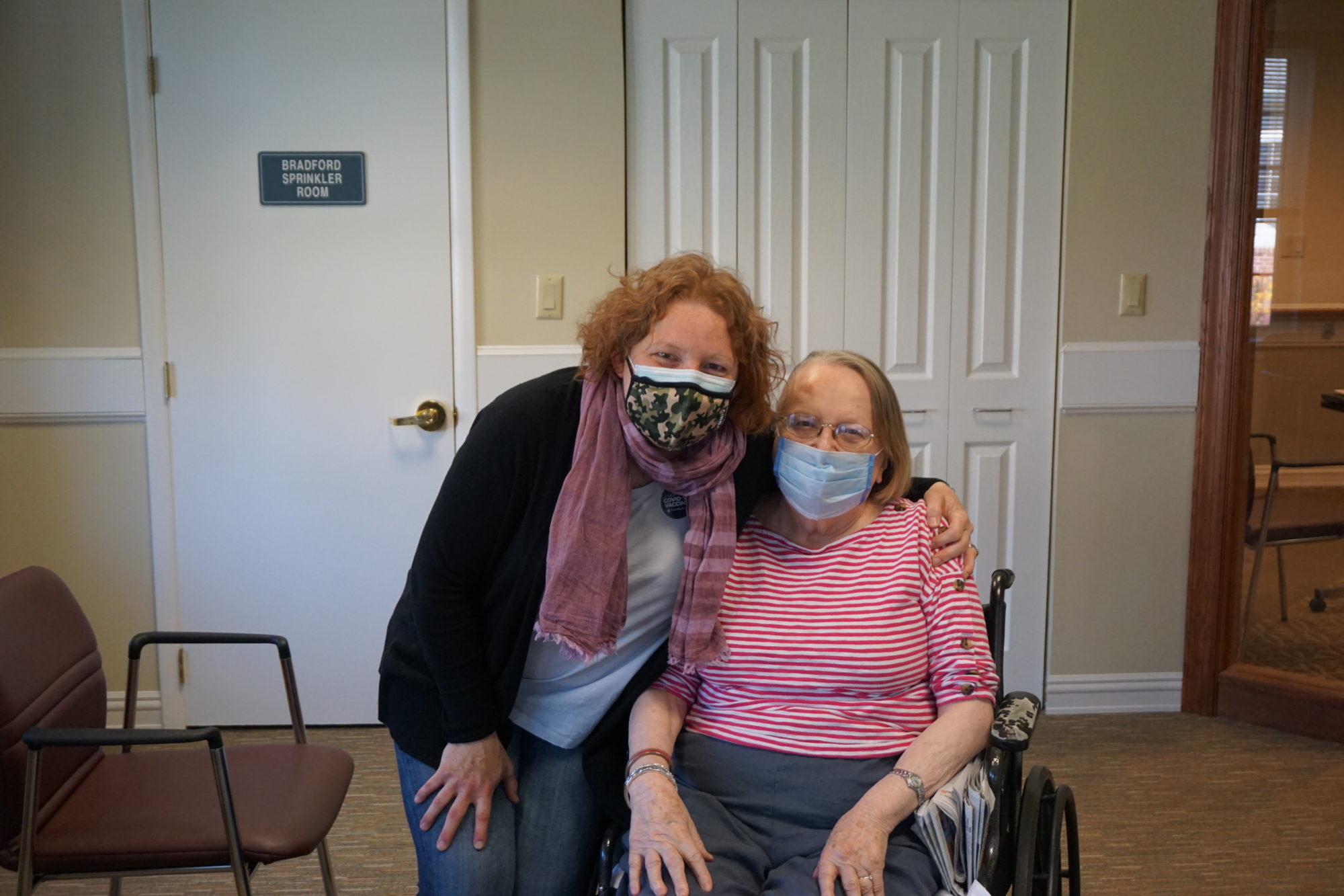 Resident and visitor hug