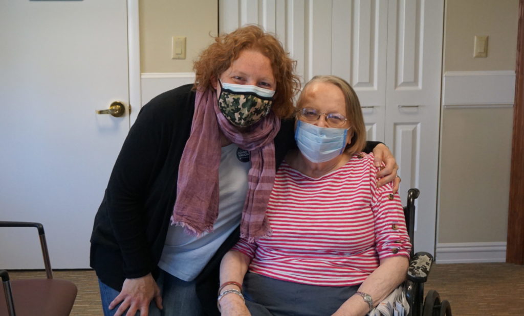 Resident and visitor hug