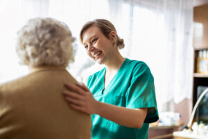 female nurse cares for senior woman in her home.